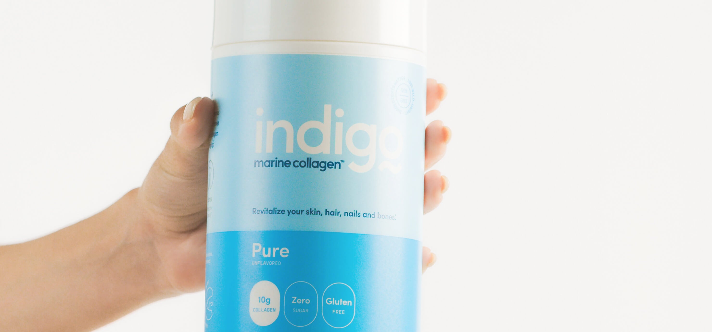 Hand Holding Unflavored Indigo Marine Collagen Peptides
