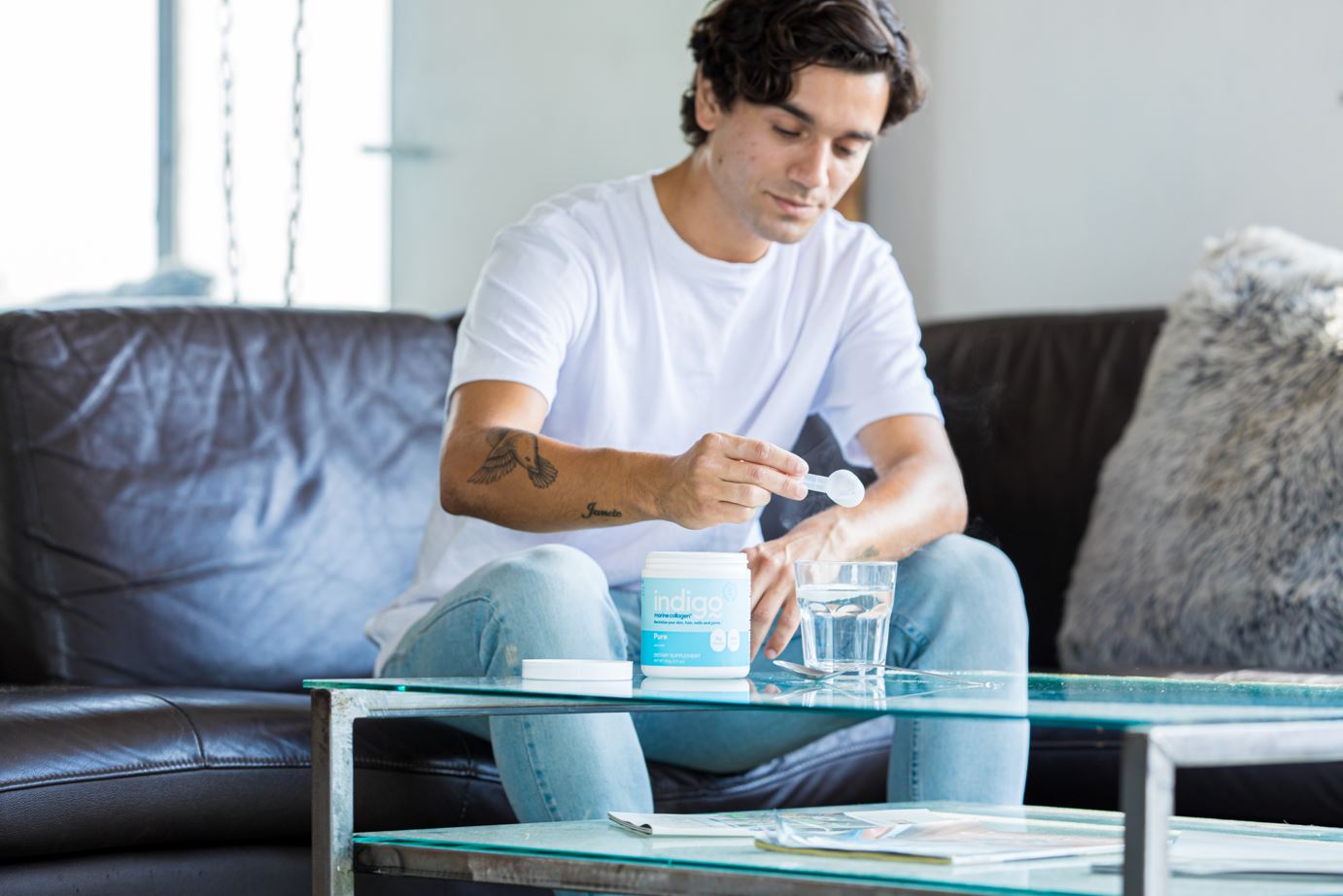 Man Mixing Indigo Marine Collagen Peptides in Glass of Water