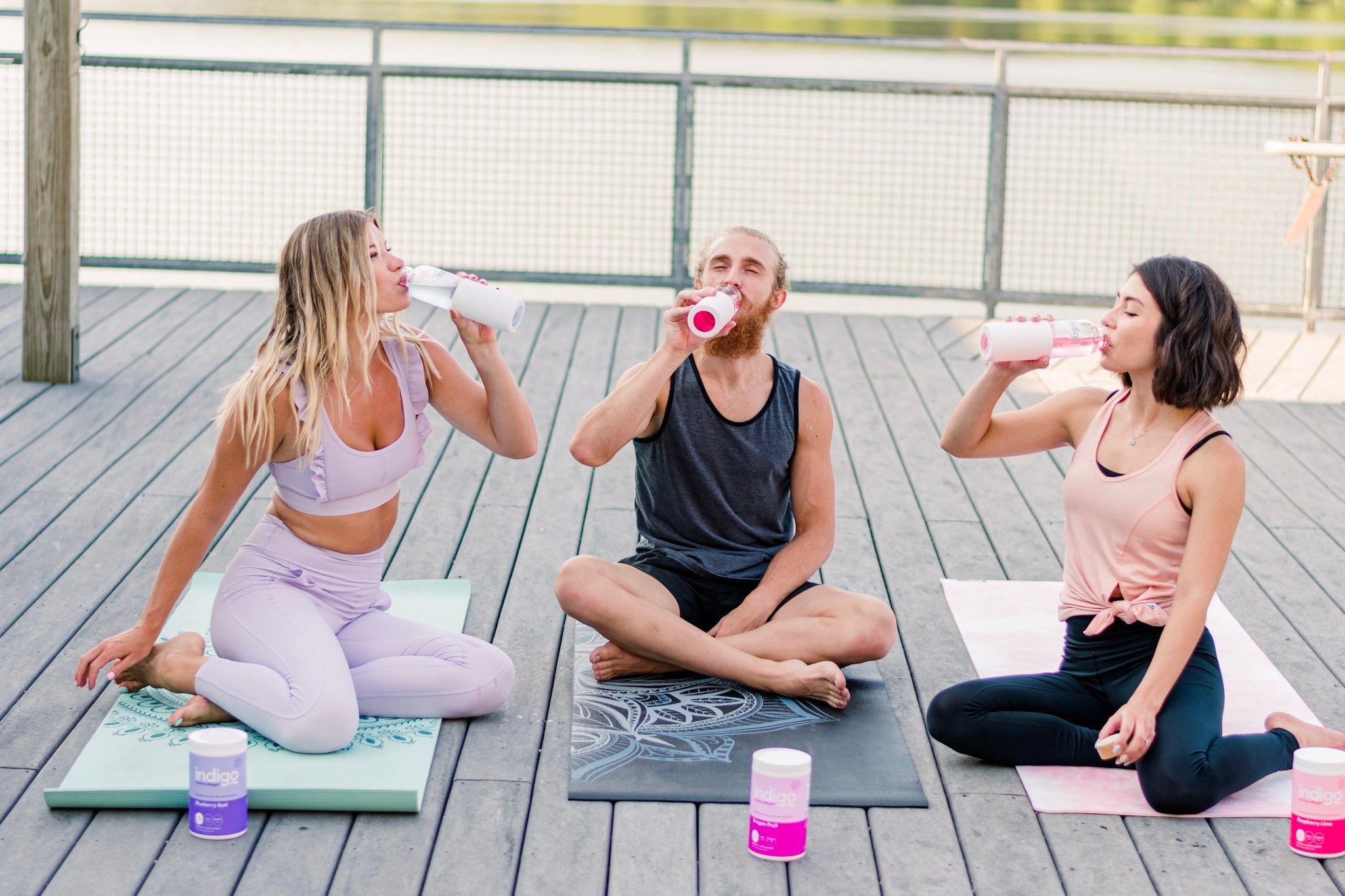 Man and Two Women Doing Yoga and Drinking Indigo Marine Collagen Peptides