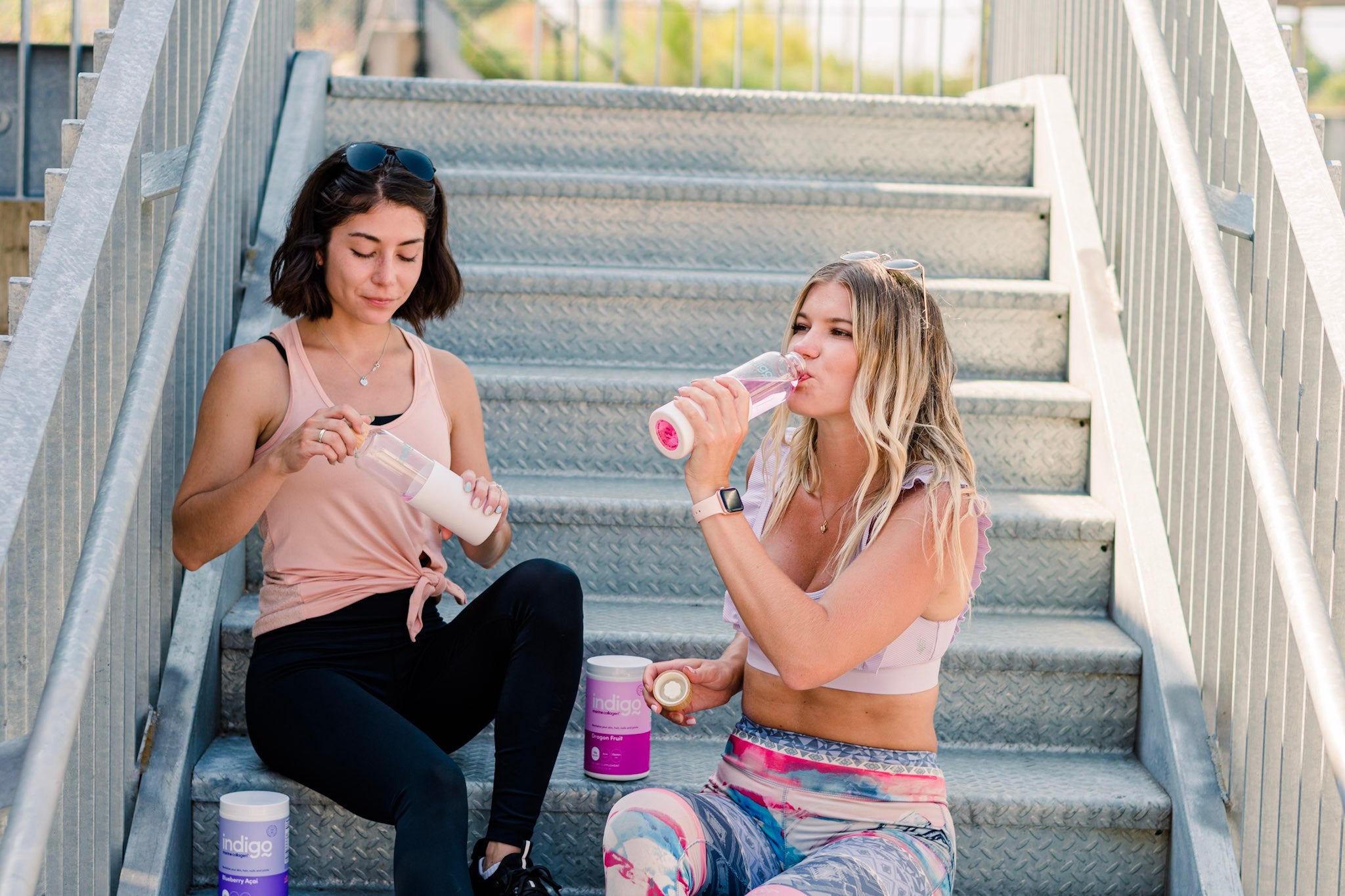 Girls on Stairs Drinking Water with Indigo Marine Collagen Peptides