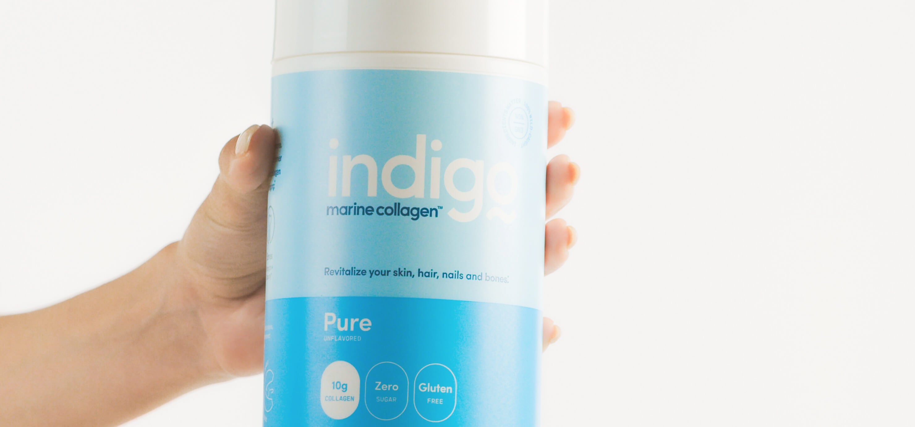 Hand Holding Unflavored Indigo Marine Collagen Peptides 