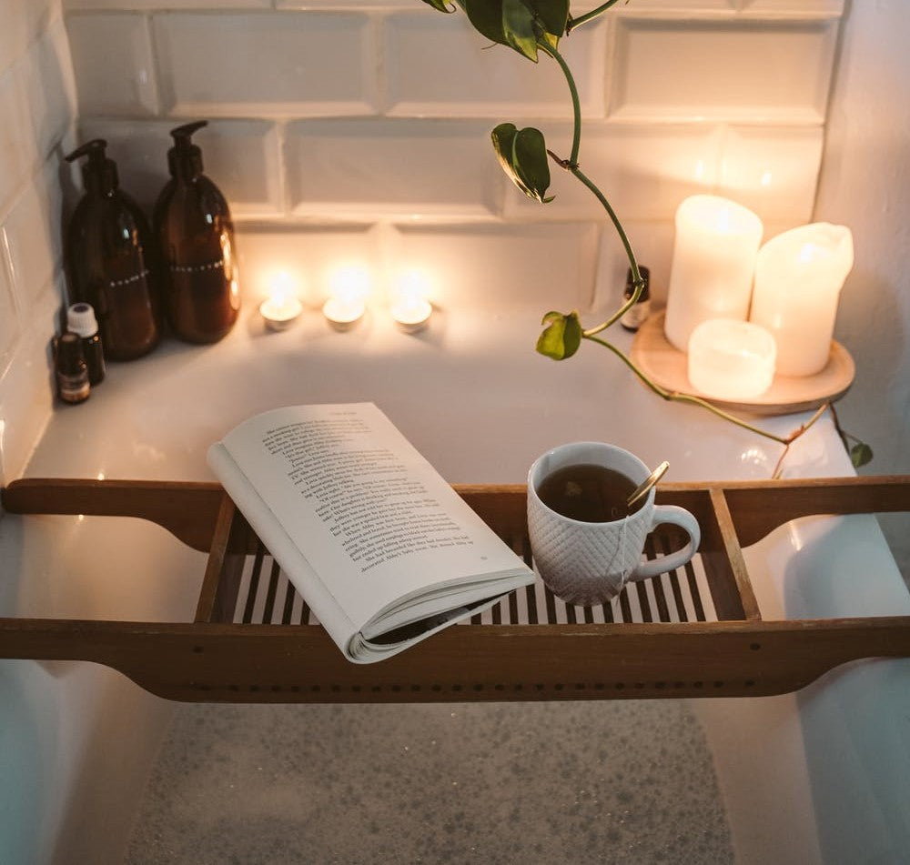 Bathtub with candles and book 